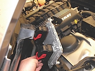 Figure 9: The easier way. After removing a few trim clips, the cowl can be pulled back to access the PCM on the 300C. The PCM is often but not always the easier choice in getting to the CKP or CMP signals. 