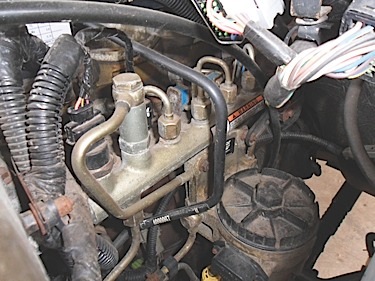 As fuel is pressurized by the common-rail injection pump, the fuel enters a storage area known as a common-rail. Notice that all the high-pressure lines for each cylinder are attached to the rail. Do not loosen the lines while the engine is running. The high-pressure fuel can pierce the skin and enter the blood stream resulting in death. Fuel pressures can reach as high as 26,000 psi.