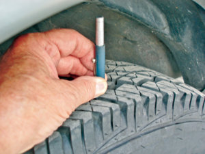 Photo 3: Routinely measuring tire tread depth is a quick way of catching a faulty camber or toe angle adjustment before the tires are ruined.