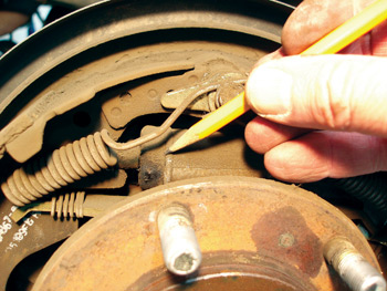 photo 5: since leaking brake fluid or axle ­lubricant will ruin new brake shoes, checking for wheel cylinder and axle shaft seal ­leakage should be a routine part of any brake inspection. 